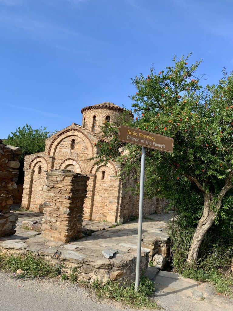 The Byzantine Church of Panagia of Fodele surrounded by lush greenery in Crete.